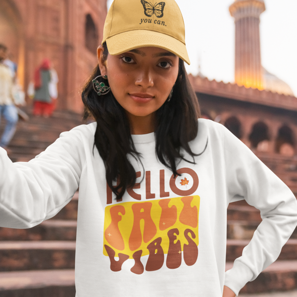 Welcoming Fall with Hello fall vibes text on white sweatshirt